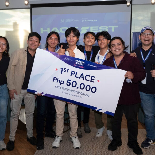 An AI-powered app called "Sustancia," developed by Team Null whose members are shown here while receiving a symbolical check, has emerged as the champion of the FlutterFlow HackFest: Impact Challenge