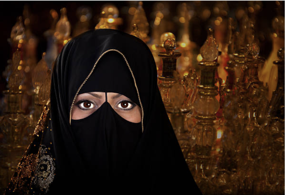 A Muslim woman surrounded by perfume