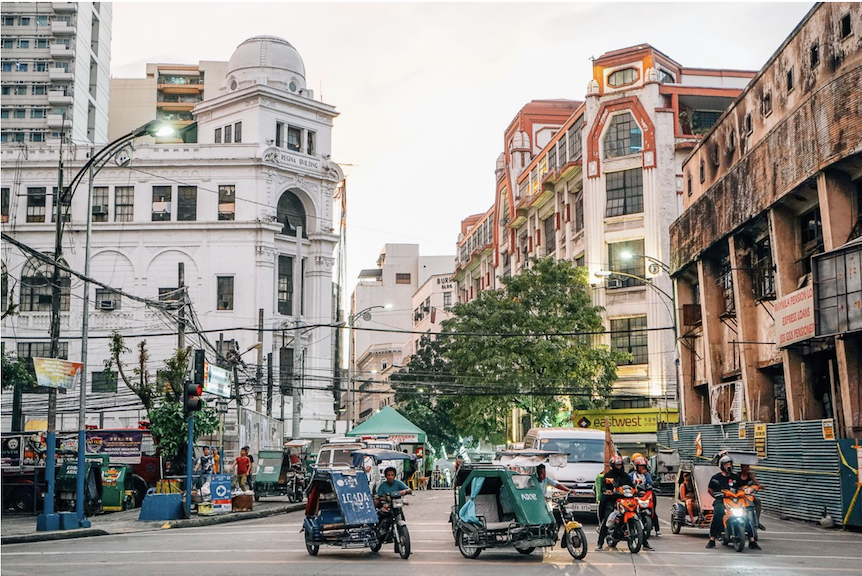 Tricycles ply around commercial buildings within today's Escolta, one of Metro Manila iconic cultural hotspots