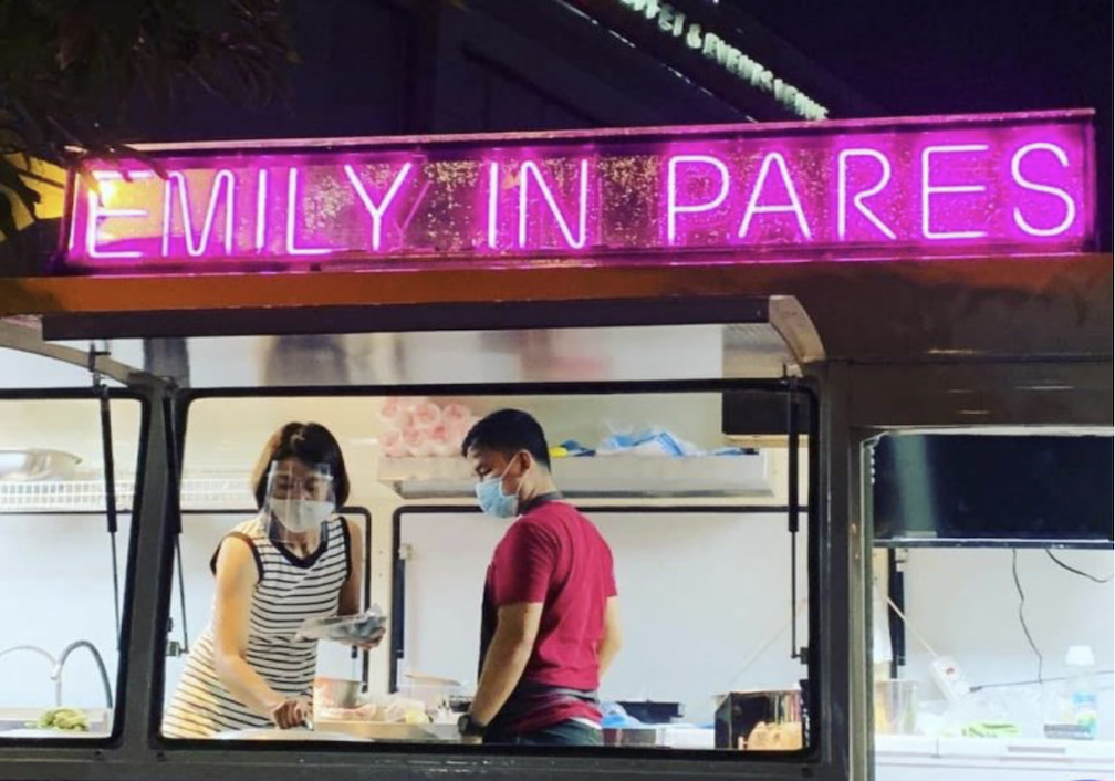 A man and a woman inside Emily in Pares, a food stall in Manila, as they join other food carts in the ₱100 Challenge