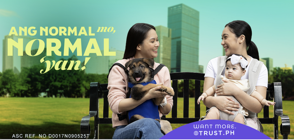 Photo of two moms, one holding a baby and the other, a dog, used as part of the Trust brand's repositioning campaign launch