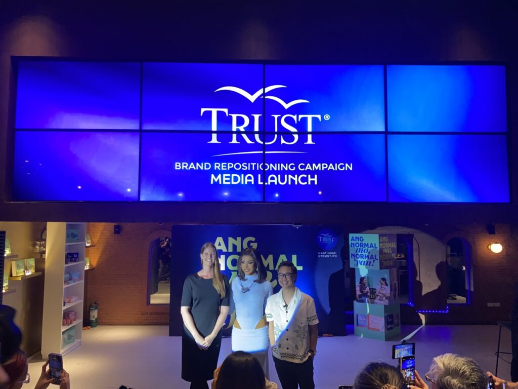 Photo shows Denise R. van Dijk, President and CEO of DKT Health, Inc., Maxie Andreison, Trust brand ambassador and winner of Drag Race Philippines Season 3, and Gil Cadiz, Director of Marketing, DKT Health, Inc., during Trust's brand repositioning campaign launch