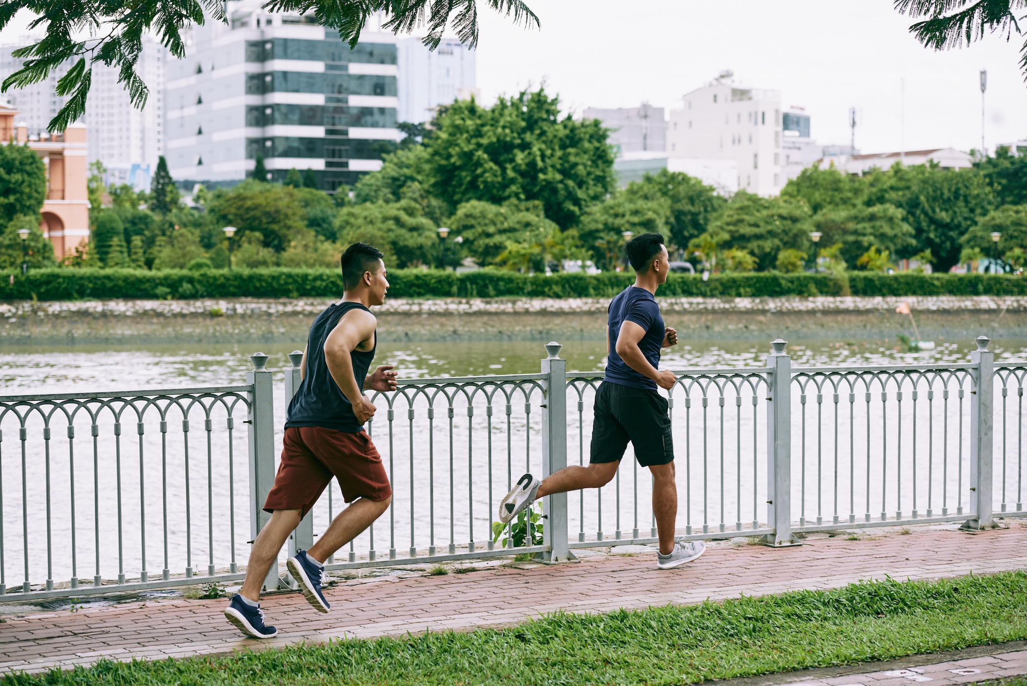 Two men jogging along the river of one of the best spots for outdoor activities in Metro Manila