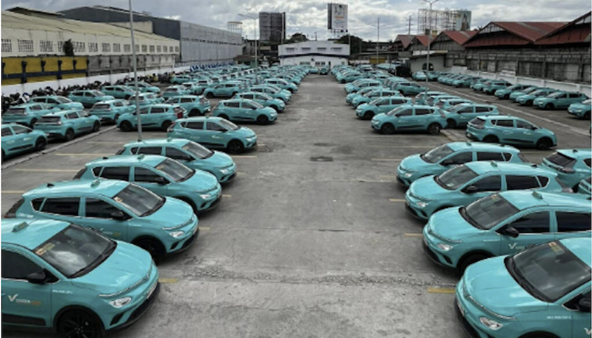 Green GSM EV taxis lined up at a compound in Cebu